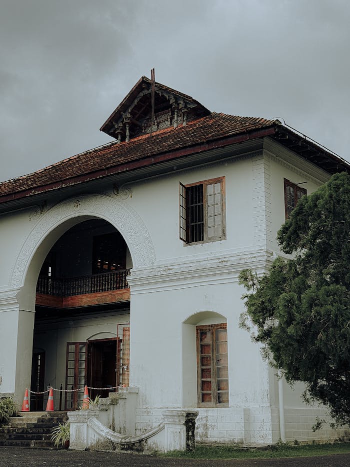 Beautiful old colonial building in Ernakulam, Kerala, showcasing historic architecture on a cloudy day.