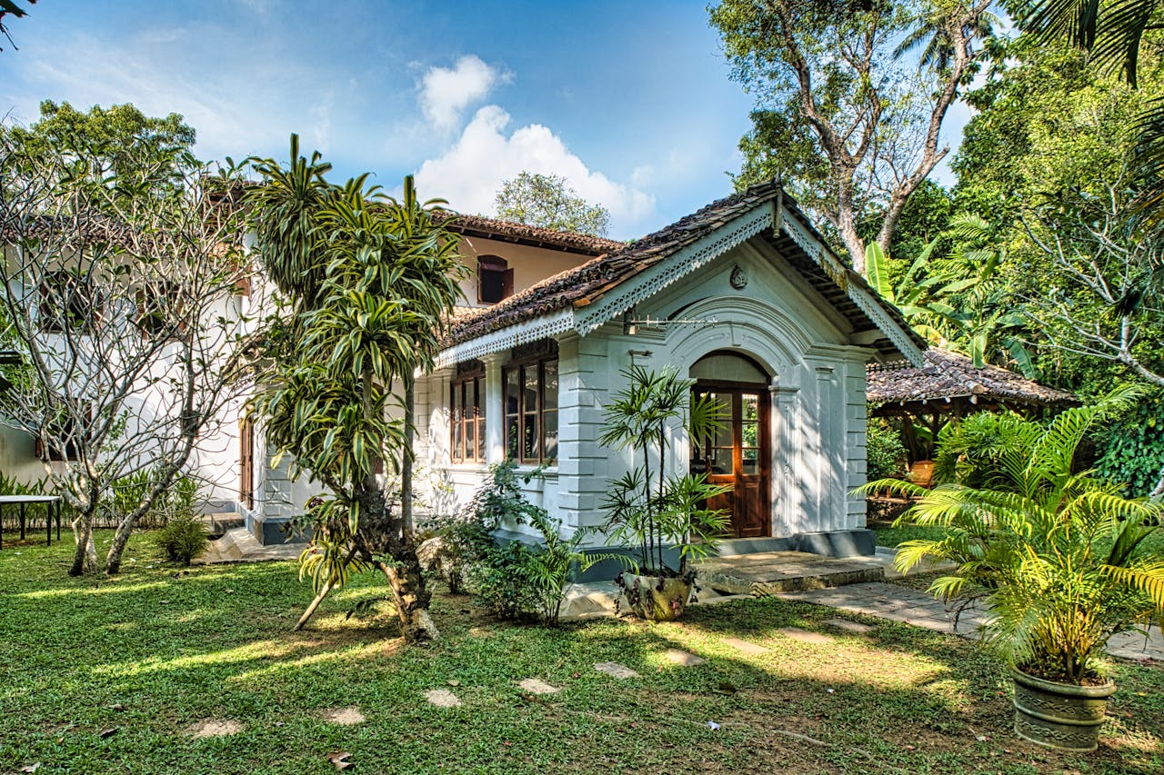 Colonial-style house surrounded by lush tropical garden in Unawatuna, Sri Lanka.